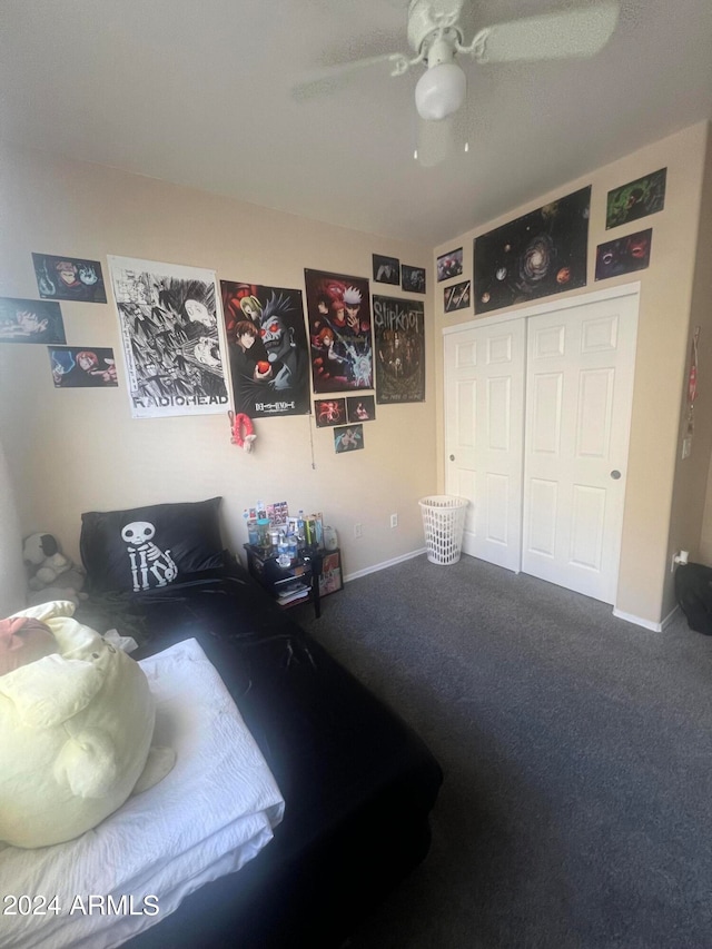 bedroom featuring ceiling fan, a closet, and carpet