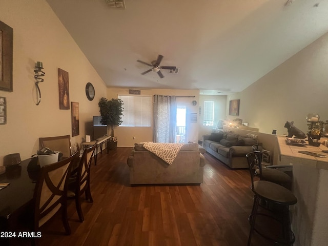 living room with vaulted ceiling, dark hardwood / wood-style floors, and ceiling fan