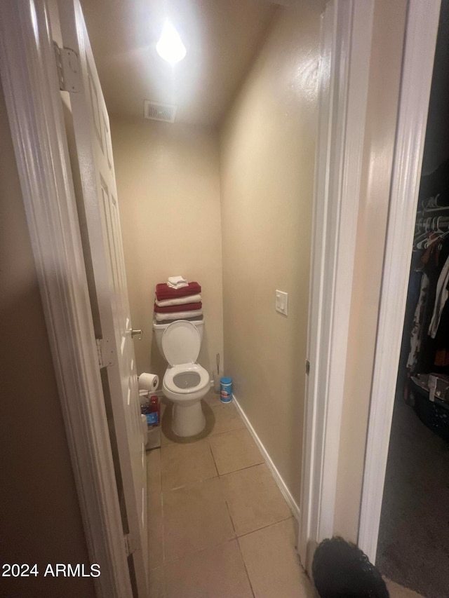 bathroom featuring toilet and tile patterned floors