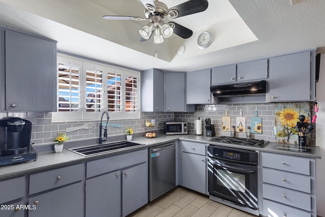 kitchen with gray cabinets, appliances with stainless steel finishes, sink, and backsplash