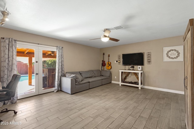 unfurnished living room featuring french doors and ceiling fan