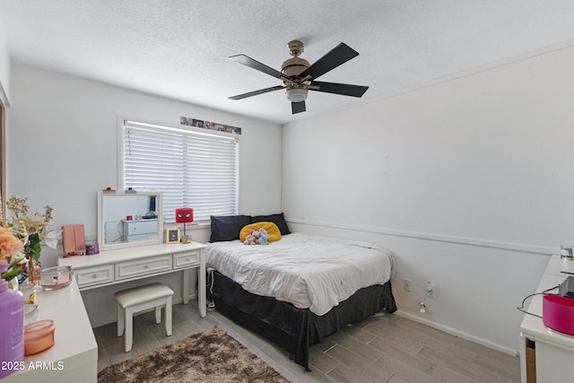 bedroom with a textured ceiling and ceiling fan