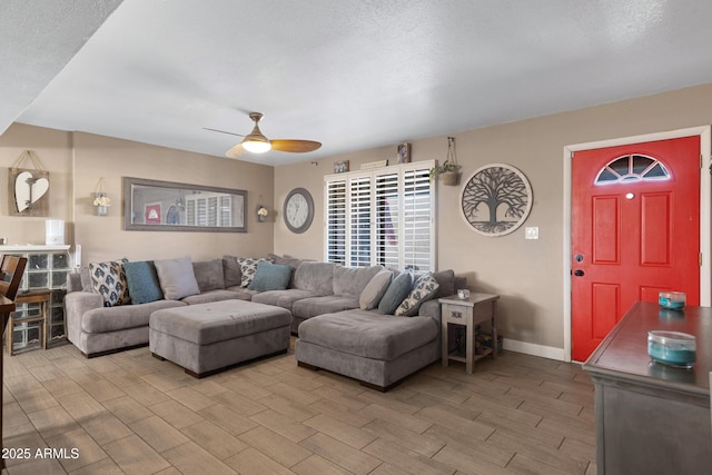 living room with a textured ceiling and ceiling fan