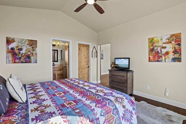 bedroom featuring ceiling fan, ensuite bathroom, dark hardwood / wood-style flooring, and vaulted ceiling