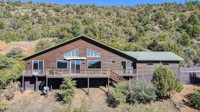 rear view of house featuring a wooden deck