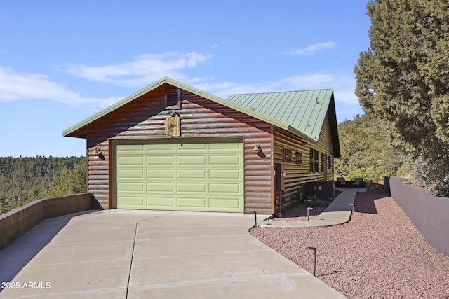 exterior space featuring a garage and an outdoor structure