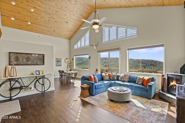 living room with wood ceiling, ceiling fan, dark hardwood / wood-style flooring, and high vaulted ceiling