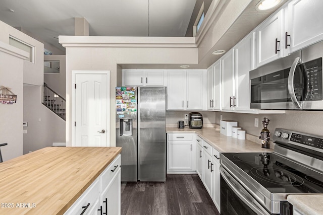 kitchen featuring dark hardwood / wood-style flooring, white cabinetry, and appliances with stainless steel finishes