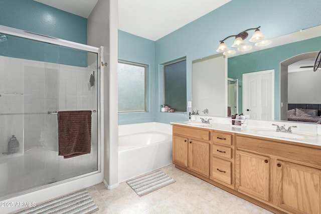 bathroom with vanity and shower with separate bathtub