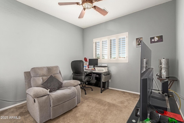 carpeted office featuring ceiling fan