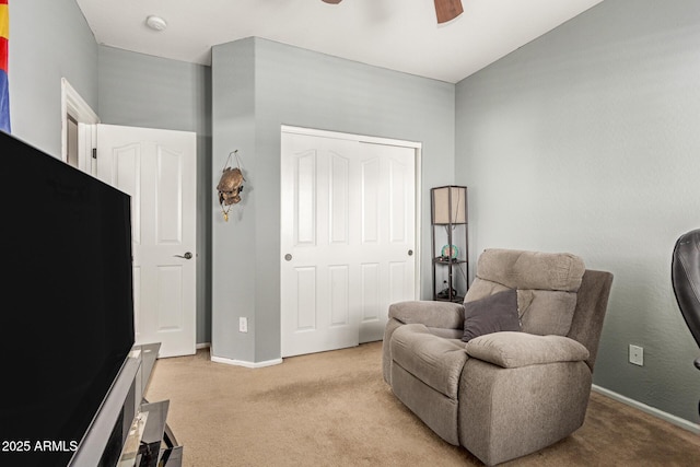 sitting room featuring light carpet and ceiling fan