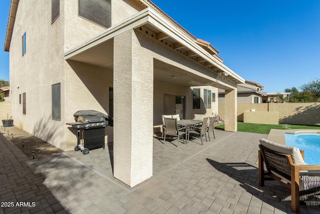 view of patio / terrace featuring a grill and a fenced in pool