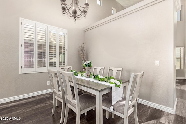 dining area with a notable chandelier and dark wood-type flooring