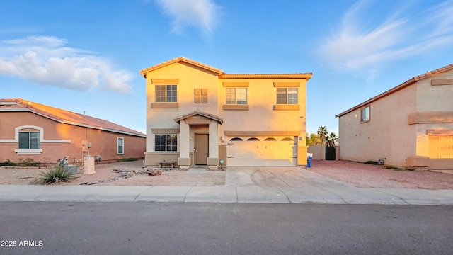6537 W Pioneer St, Phoenix, AZ 85043 - mediterranean / spanish house with an attached garage, stucco siding, concrete driveway, and a tiled roof