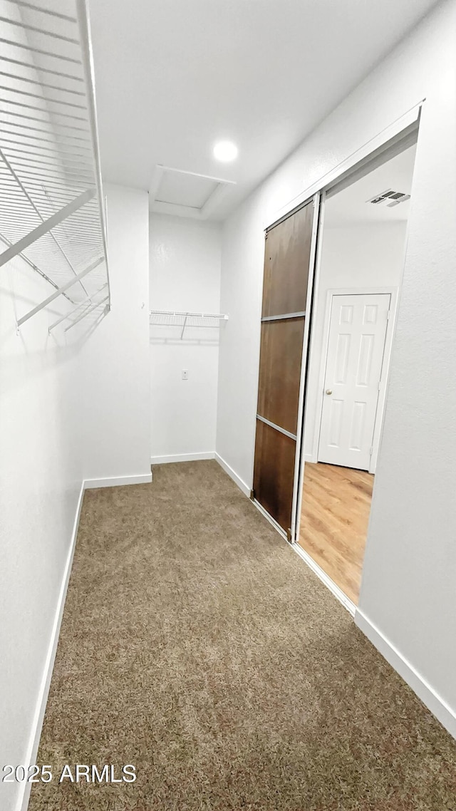 6537 W Pioneer St, Phoenix, AZ 85043 - walk in closet featuring carpet flooring and attic access