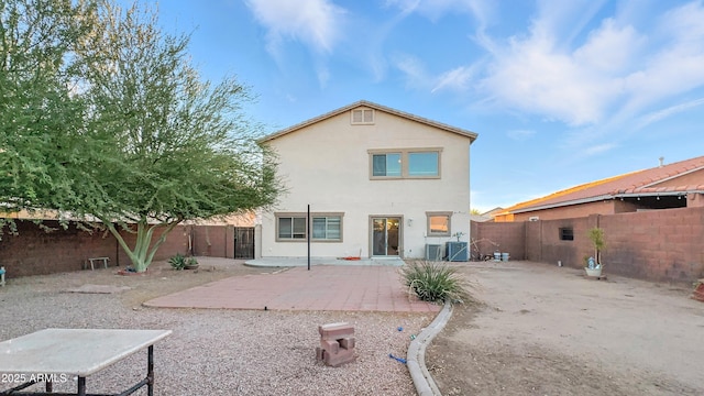6537 W Pioneer St, Phoenix, AZ 85043 - back of property with stucco siding, a patio area, a fenced backyard, and a gate