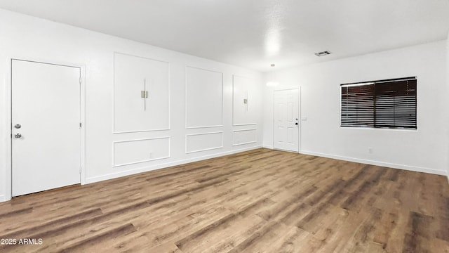 6537 W Pioneer St, Phoenix, AZ 85043 - unfurnished room featuring wood finished floors and baseboards