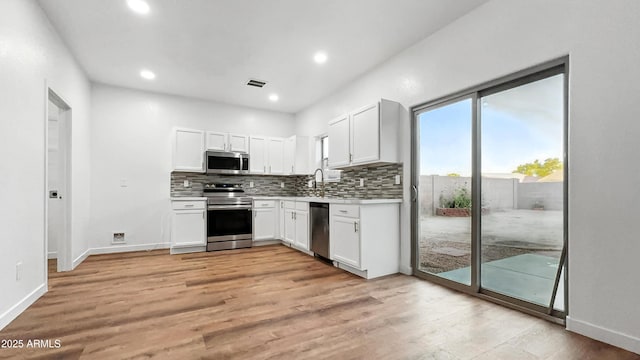 6537 W Pioneer St, Phoenix, AZ 85043 - kitchen with stainless steel appliances, light countertops, tasteful backsplash, white cabinetry, and recessed lighting