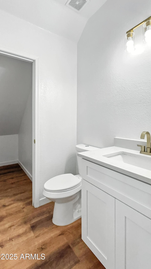 6537 W Pioneer St, Phoenix, AZ 85043 - half bath with vaulted ceiling, vanity, and wood finished floors