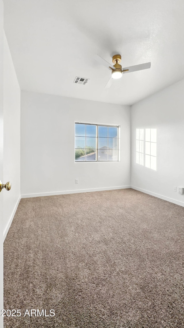 6537 W Pioneer St, Phoenix, AZ 85043 - empty room with a ceiling fan, plenty of natural light, and carpet flooring