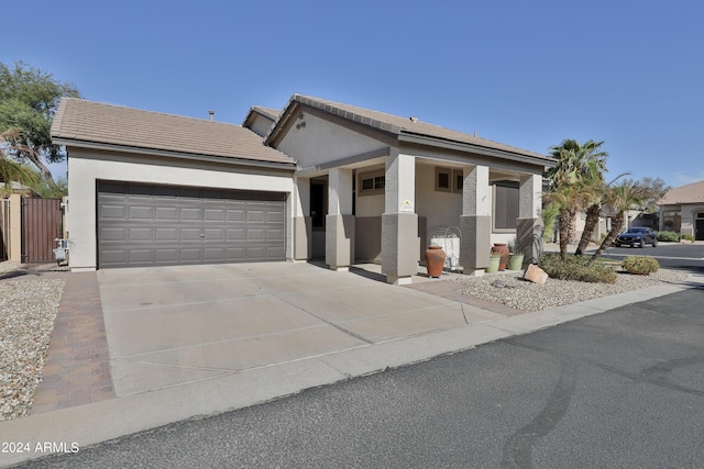 view of front of home featuring stucco siding, a garage, and concrete driveway