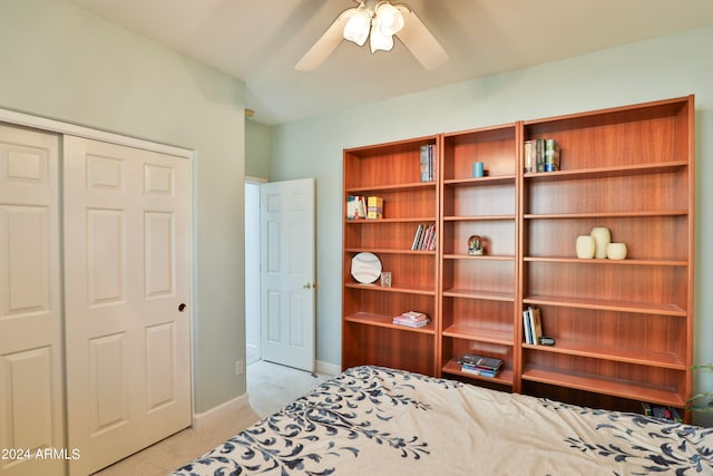 carpeted bedroom with a closet and ceiling fan