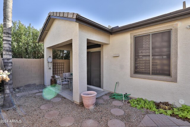 view of exterior entry featuring a patio