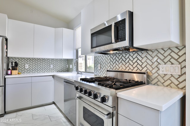 kitchen with white cabinets, stainless steel appliances, and decorative backsplash