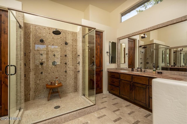 bathroom with walk in shower and vanity