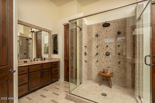 bathroom with tile patterned floors, vanity, and a shower with shower door