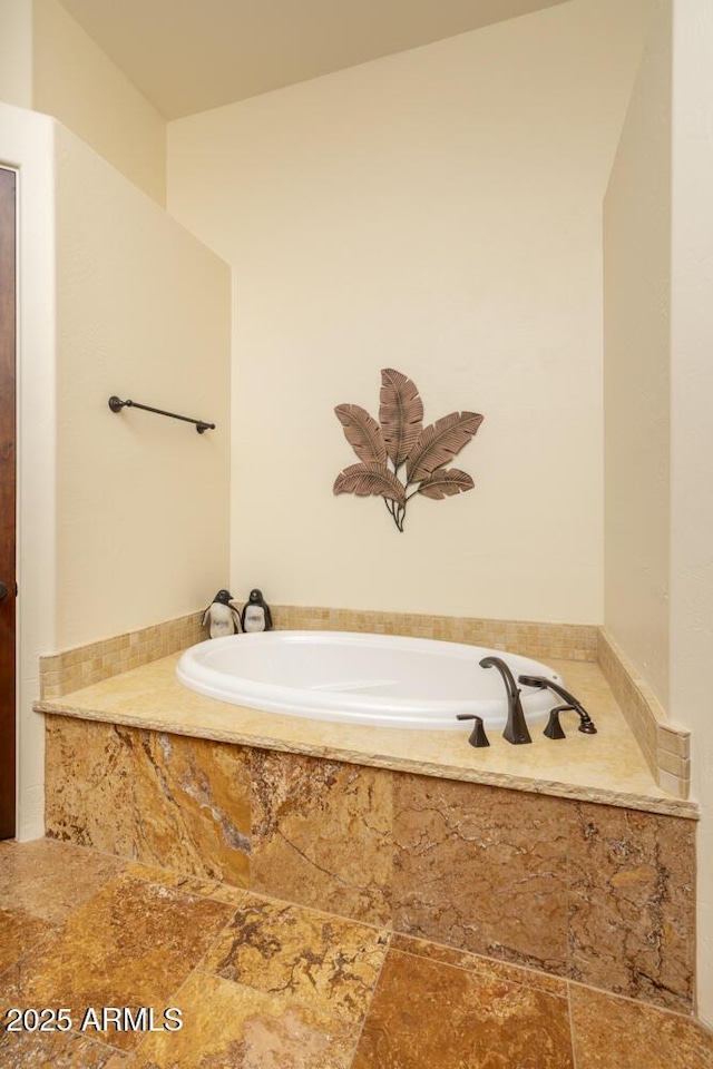 bathroom with tiled tub