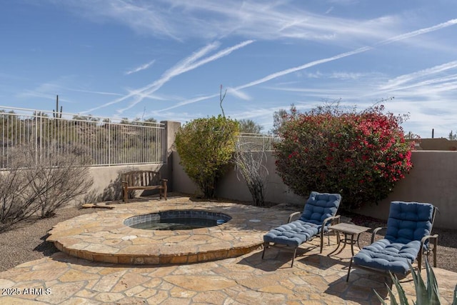 view of patio with an in ground hot tub