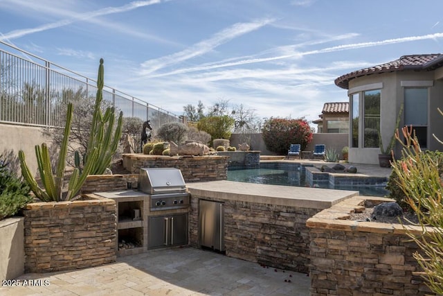 view of patio / terrace featuring pool water feature, an outdoor kitchen, a fenced in pool, and area for grilling