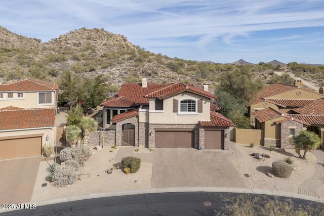 mediterranean / spanish house featuring a garage and a mountain view