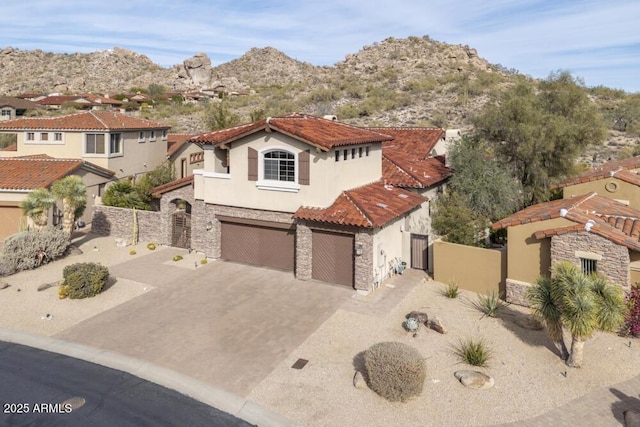 mediterranean / spanish-style home featuring a garage and a mountain view