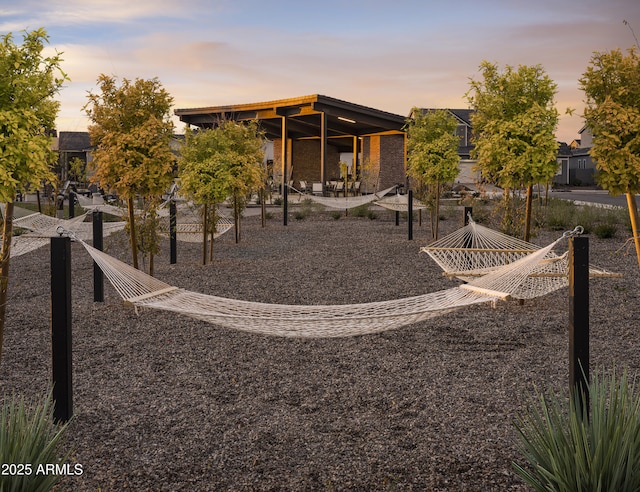 back of house at dusk with a patio area