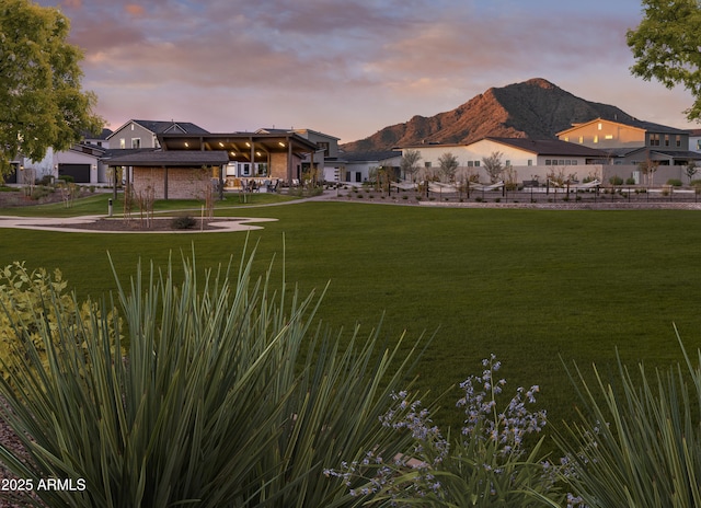 yard at dusk featuring a mountain view