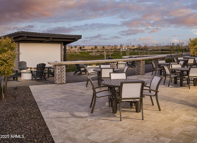 patio terrace at dusk with outdoor dining area