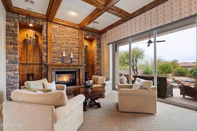 living room featuring coffered ceiling, a stone fireplace, and beam ceiling