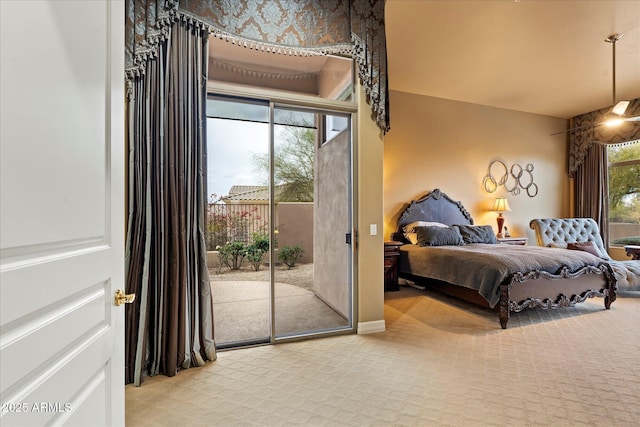 carpeted bedroom featuring multiple windows and access to outside