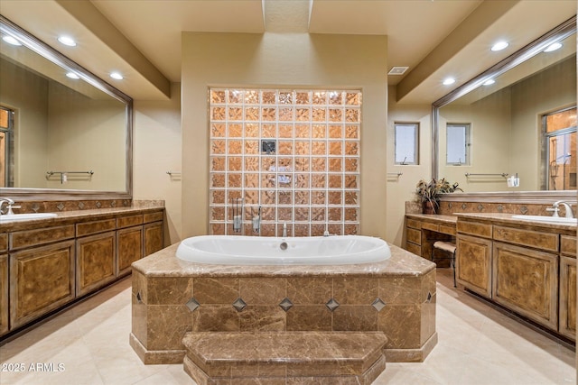 bathroom featuring vanity, tiled bath, and tile patterned floors