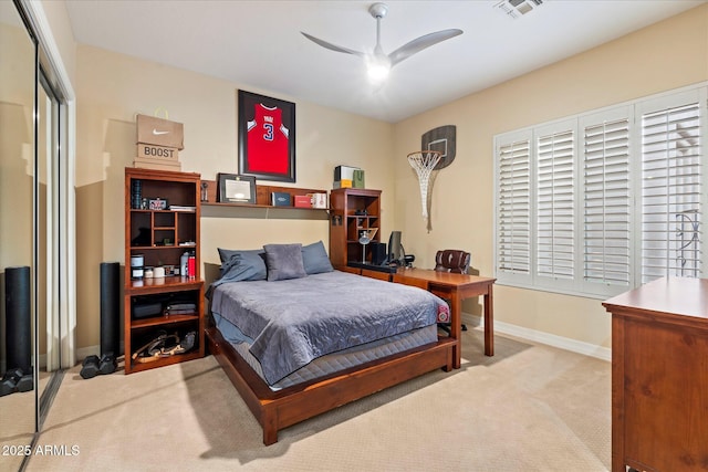 carpeted bedroom with ceiling fan and a closet