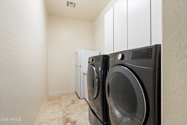 washroom with cabinets and separate washer and dryer