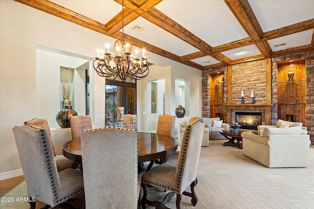 dining area with coffered ceiling, a chandelier, and beam ceiling