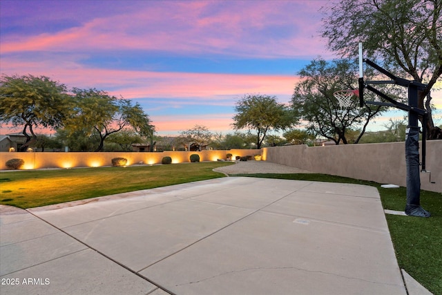 view of basketball court featuring a lawn