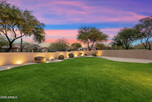 view of yard at dusk