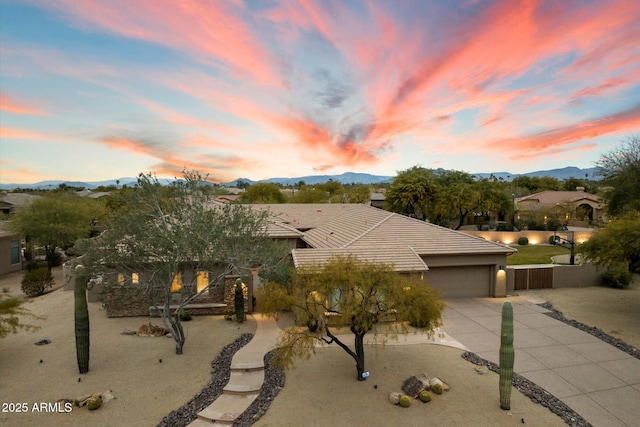 view of front of property with a garage and a mountain view