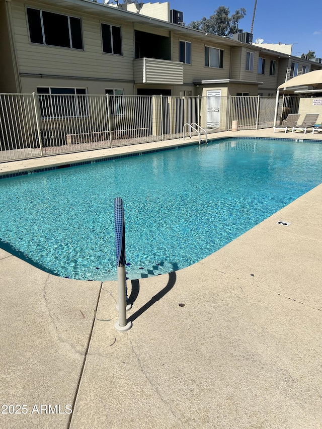 community pool featuring central AC unit and fence