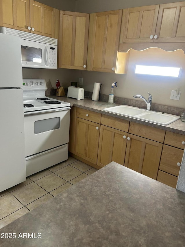 kitchen with white appliances, light tile patterned flooring, light brown cabinetry, and a sink