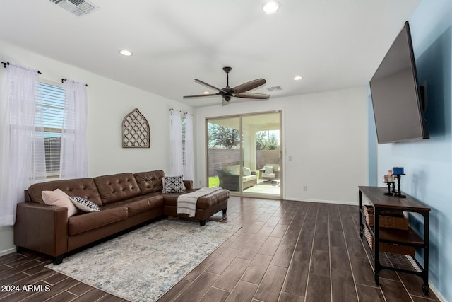 living room with dark hardwood / wood-style floors and ceiling fan